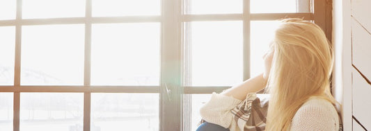 portrait of young blonde woman thinking indoor